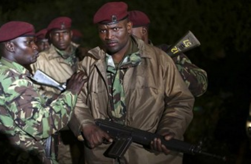 Kenyan soldiers hold their rifles near Westgate  (photo credit: Reuters)