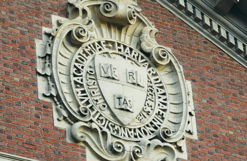 A seal hangs over a building at Harvard University  (photo credit: Reuters)