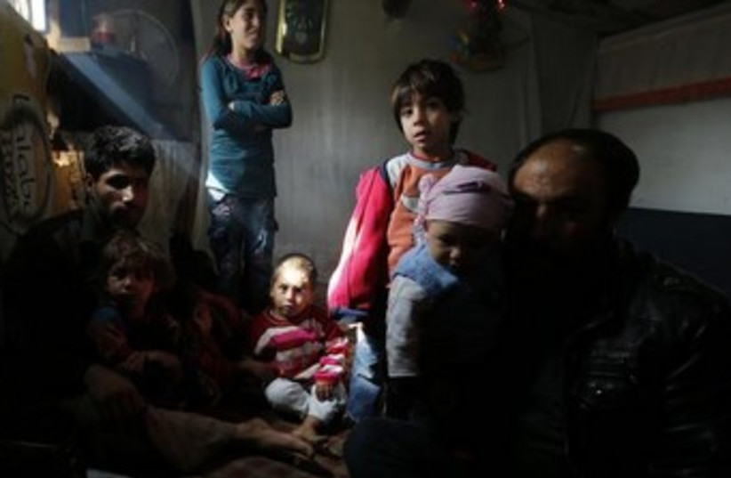 Syrian refugees spend time in their makeshift tents (photo credit: Reuters)