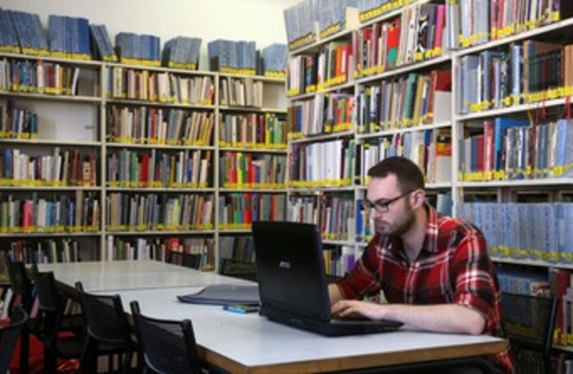 Student with laptop at Bezalel library 370 (photo credit: Marc Israel Sellem/The Jerusalem Post)