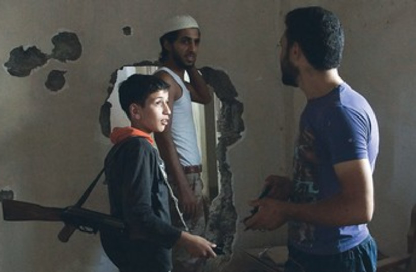 Free Syrian Army child fighter 370 (photo credit: Khalil Ashawi/Reuters)