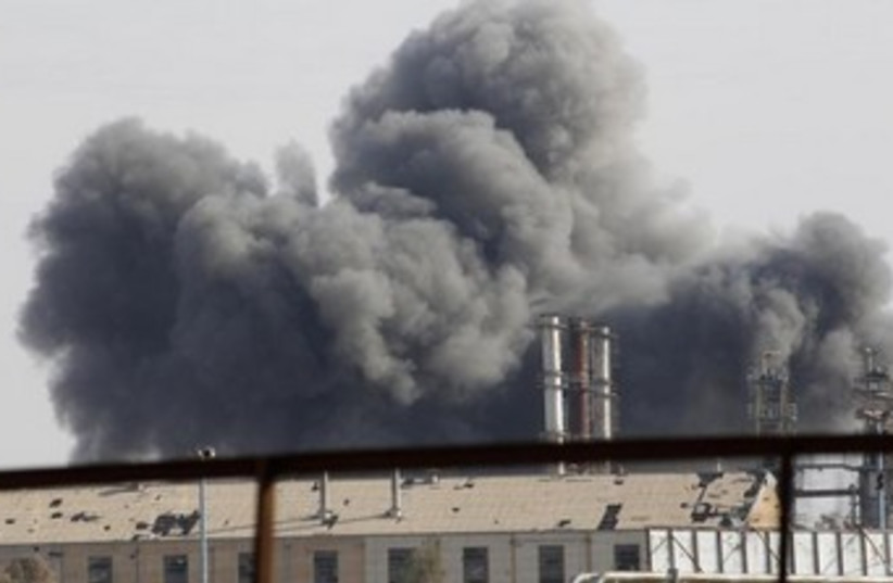Smoke rises due to clashes in the Syrian town of Raqqa 370 (photo credit: REUTERS)