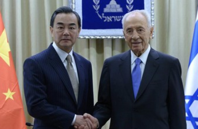 Peres and Chinese FM Wang Yi 370 (photo credit: Mark Neiman, GPO)