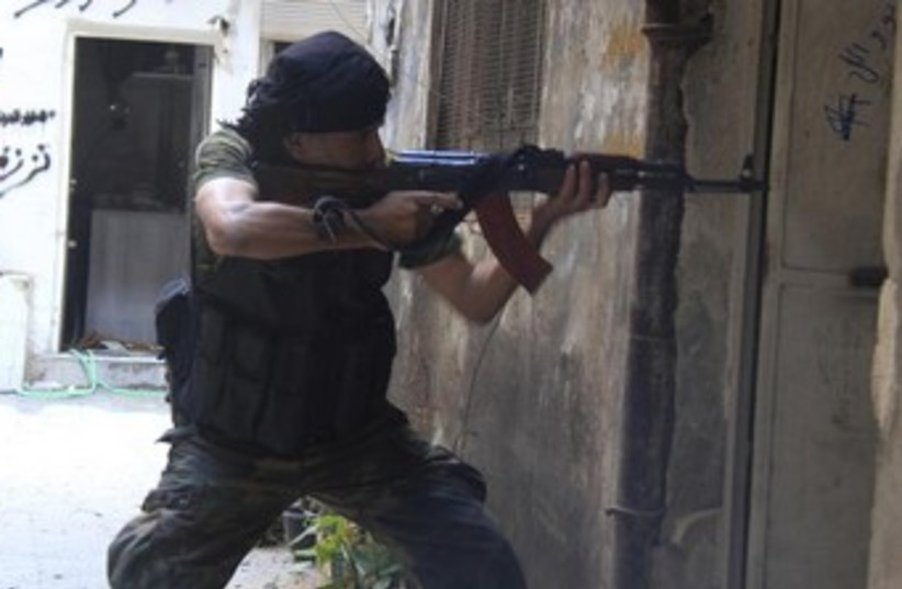 A Free Syrian Army fighter in the Yarmouk district  (photo credit: Reuters)