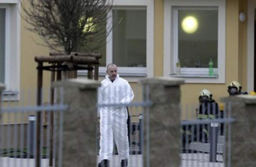An investigator works at the site of the explosion in Prague January 1, 2014. (photo credit: REUTERS)