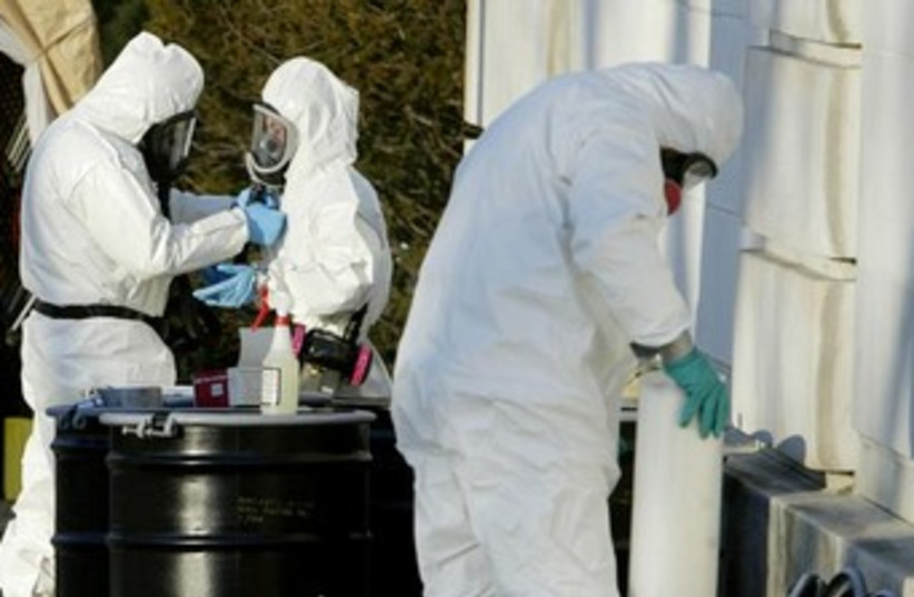 Officials in protective suits handle anthrax [file] (photo credit: REUTERS)