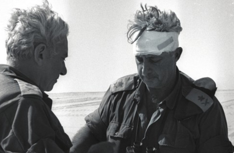Former Chief of Staﬀ Haim Bar-Lev consults with Maj. Gen. Ariel Sharon during the Yom Kippur War, 1973 (photo credit: YOSSI GREENBERG / GPO)