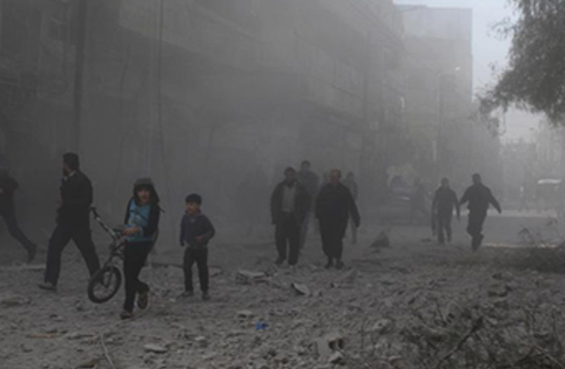 Human rights group report says Assad regime razing entire neighborhoods‏ (photo credit: REUTERS)