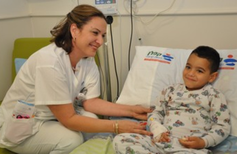 Little Uri Mazuz with nurse Iris Lisha.  (photo credit: KAPLAN MEDICAL CENTER)