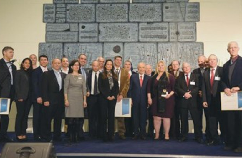 REPRESENTATIVES OF local firms pose with President Shimon Peres and Economy Minister Naftali Bennett at an awards ceremony for outstanding exporters held at the President’s Residence on Tuesday. (photo credit: Mark Neiman/GPO)