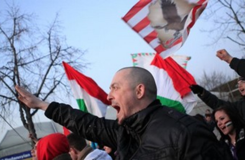 Hungarian far-rightists shout slogans outside a soccer match. (photo credit: REUTERS)