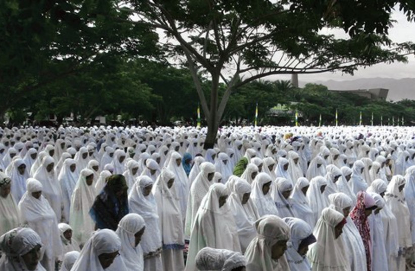 Women attend a mass Eid al-Adha prayer in Banda Aceh, Indonesia, last October (photo credit: REUTERS)