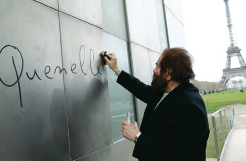 The word ‘quenelle,’ an anti-Semitic reference, is removed from ‘The Wall For Peace’ in Paris. (photo credit: REUTERS)