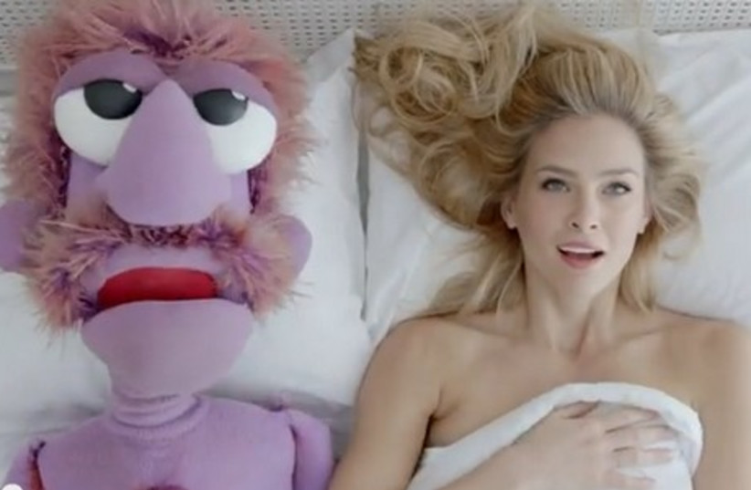 Bar Refaeli in bed with a muppet for the Hoodies commercial (photo credit: YOUTUBE SCREENSHOT)