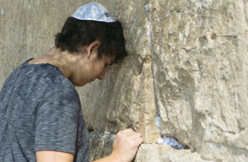 A PARTICIPANT in Chai Lifeline’s ‘Wish at the Wall’ trip prays at the Kotel in Jerusalem. (photo credit: CHAI LIFELINE)