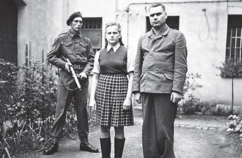 A British soldier guards Bergen-Belsen warden Irma Grese, 22, photographed in August 1945 with Josef Kramer, the commandant of the concentration camp (photo credit: COURTESY IMPERIAL WAR MUSEUM)