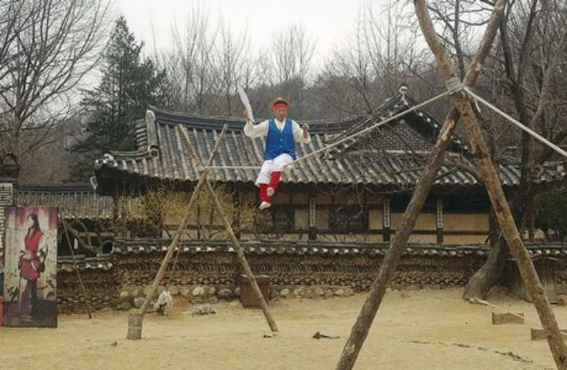 A tightrope walker performs at Minsok, a folk village dedicated to recreating traditional Korean day-to-day life. (photo credit: NOA AMOUYAL)