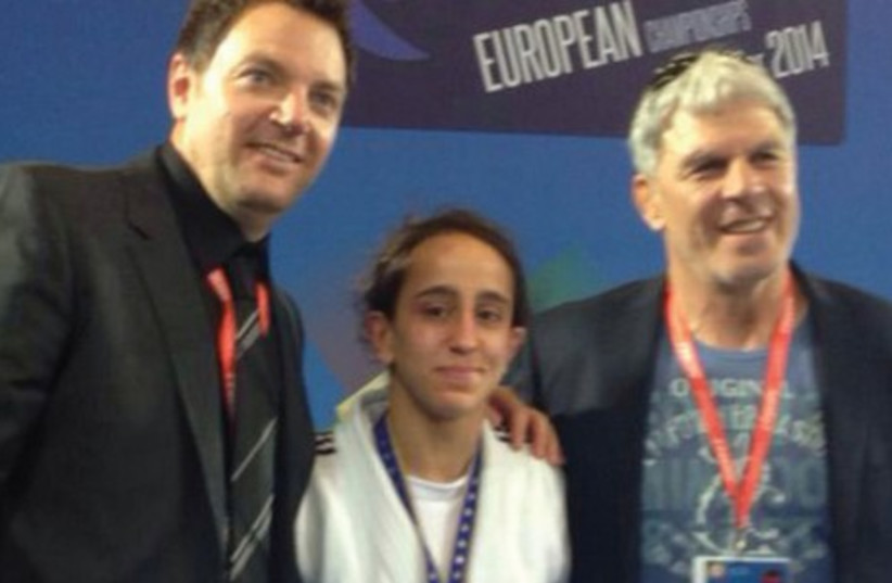 Gili Cohen (center) poses for pictures with coach Shany Hershko (left) and Israel Judo Association chairman Moshe Ponti (right) after winning a bronze medal at the European Judo Championships.  (photo credit: IJAI/COURTESY)