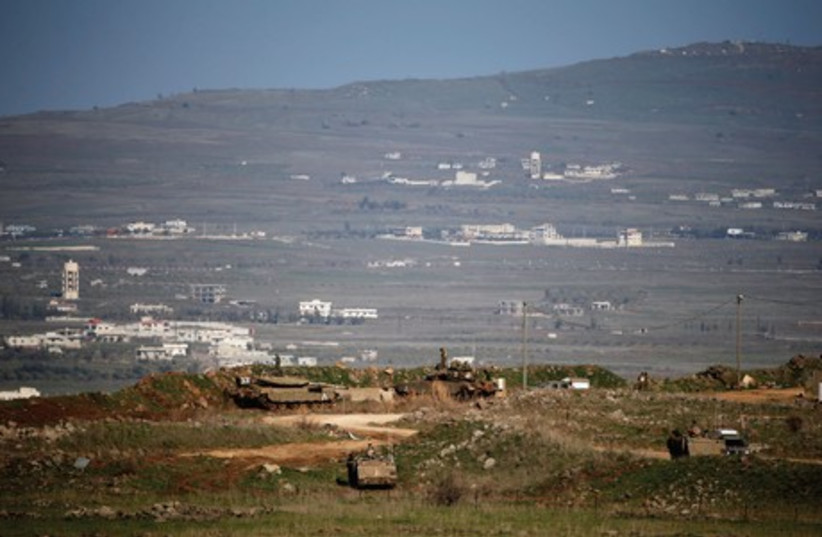 Soldiers patrol the Golan Heights. Israel has yet to demarcate a border with Syria and other borders remain politically disputed. (photo credit: REUTERS)