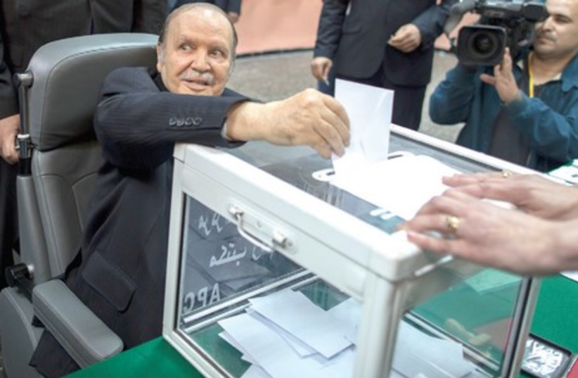 Algeria’s wheelchair-bound President Abdelaziz Bouteflika casts his ballot during the presidential election in Algiers, April 17 (photo credit: ZOHRA BENSEMRA/REUTERS)