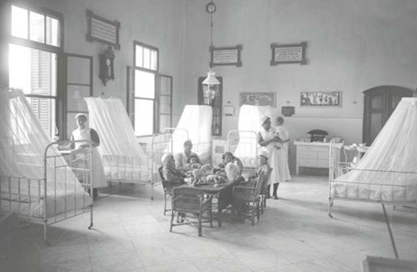 Children comforted by toys at Shaare Zedek Hospital, 1908. (photo credit: THE SHAARE ZEDEK MEDICAL CENTER COLLECTION, JERUSA)