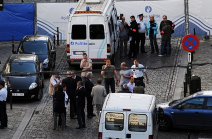 Police personnel are seen at the site of a shooting in central Brussels, May 24, 2014. (photo credit: REUTERS)