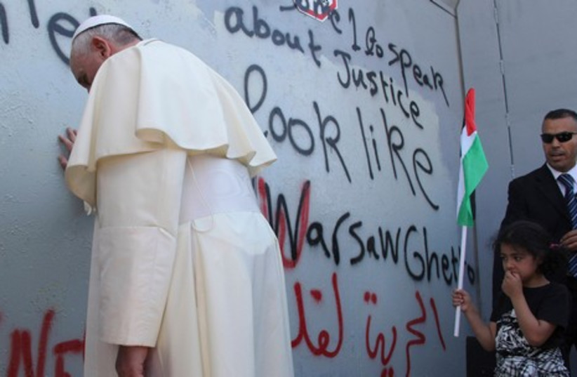 Pope Francis at the West Bank separation barrier (photo credit: REUTERS)