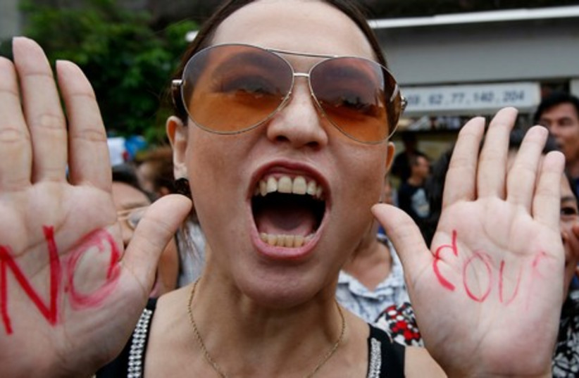 A protester chants slogans during a rally against military rule at Victory Monument in Bangkok, May 27, 2014. (photo credit: REUTERS)