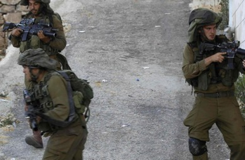 IDF soldiers from the Paratroopers Brigade search for the missing teens near Hebron. (photo credit: REUTERS)