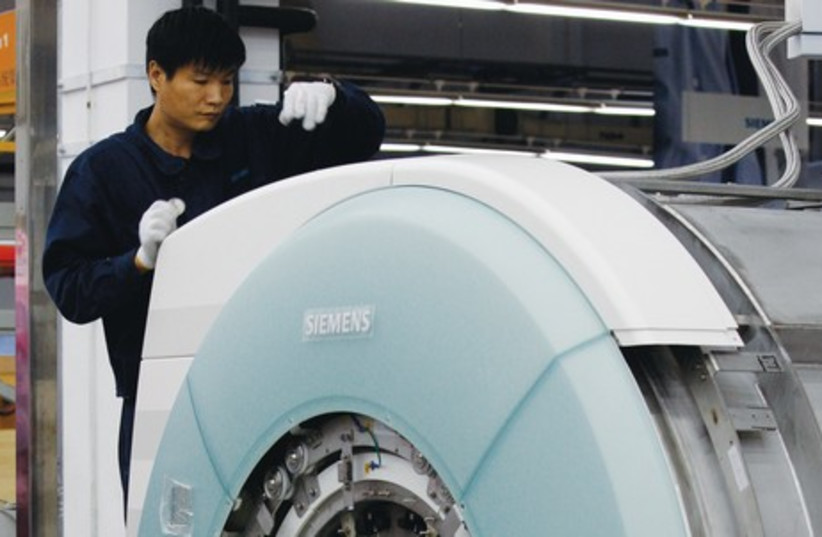 An MRI machine being assembled (photo credit: REUTERS)
