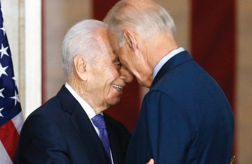 PRESIDENT SHIMON PERES embraces US Vice President Joe Biden after  receiving the Congressional Gold Medal in Washington yesterday. (photo credit: REUTERS)