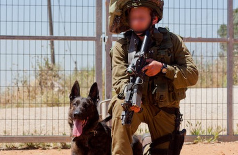 An IDF soldier in the elite Oketz unit with his dog. (photo credit: IDF)
