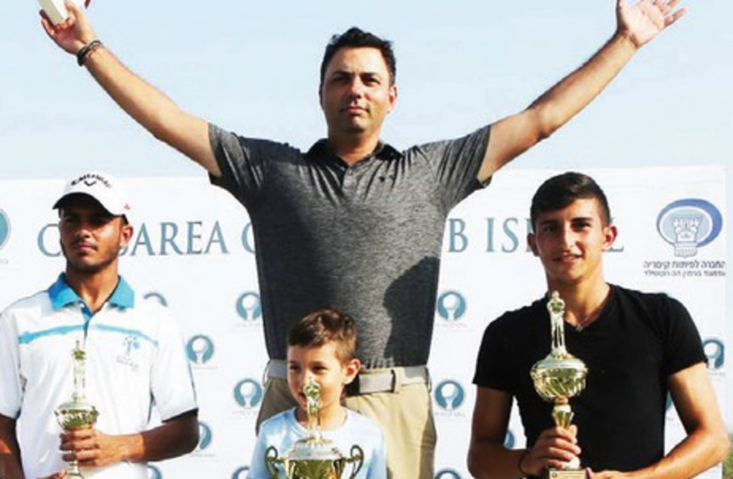 Men’s Open gross-score winners at the Caesarea Club Championship – first-place Roie Edelman and his son (center), second-pace Eitan Solomon (right) and third-place Dolev Gueta (left) pose with their trophies after the tournament (photo credit: Courtesy)
