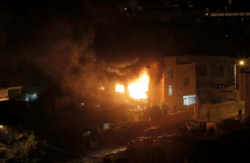 IDF blasts into home of suspect in Hebron (photo credit: REUTERS)