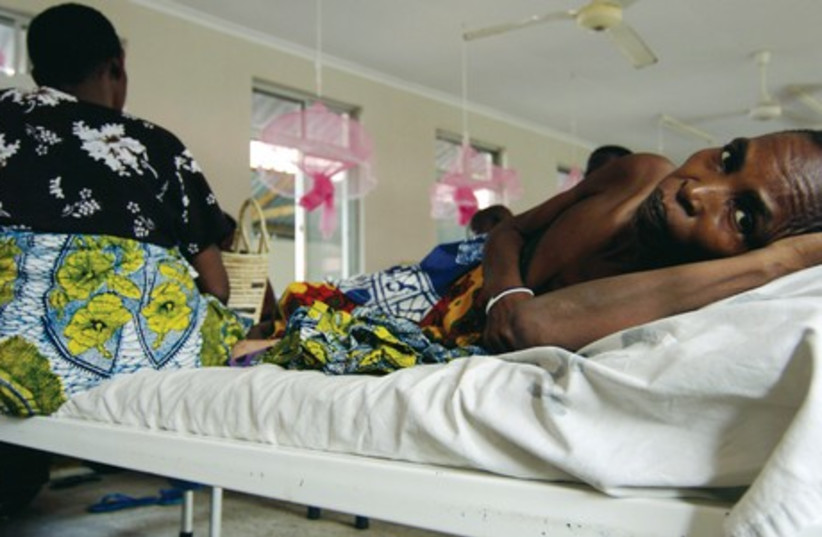 Cancer patients share a bed in the female ward of Tanzania’s cancer institute in the capital Dar es Salaam in this photo from November 11, 2009. Many women worldwide who are diagnosed with cervical cancer live in the developing world and a high percentage in Africa (photo credit: REUTERS)