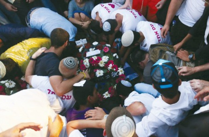 Mourners gather at the grave of Gil-Ad Shaer on Tuesday. (photo credit: MARC ISRAEL SELLEM/THE JERUSALEM POST)