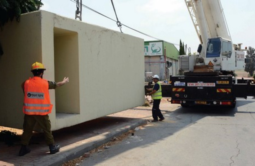 DOZENS OUT of 86 new bomb shelters are being placed along streets in towns near the Gaza Strip over the weekend. They are an anonymous contribution made by a major donor from Keren Hayesod-United Israel Appeal, for the residents of the South. (photo credit: AVI HAYOUN)