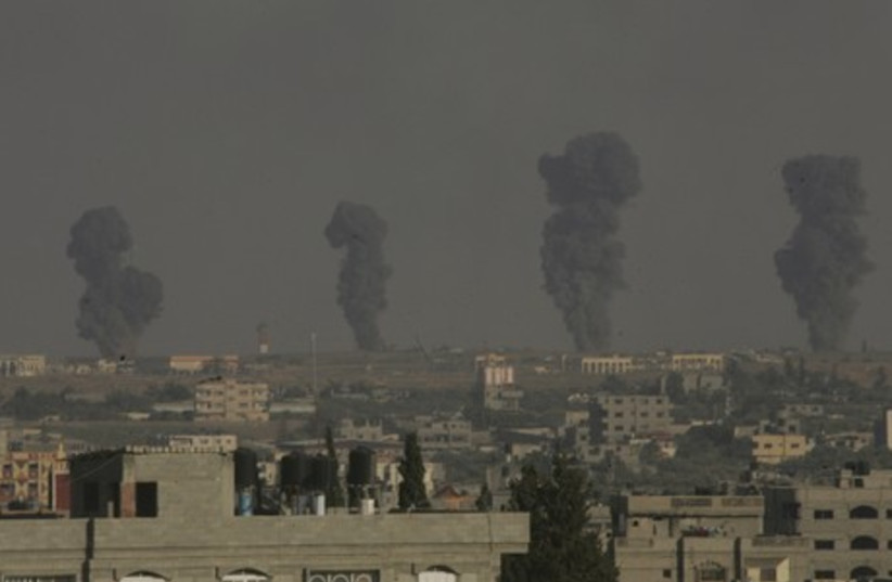 Plumes of smoke are seen following an Israeli military strike in southern Gaza. (photo credit: REUTERS)