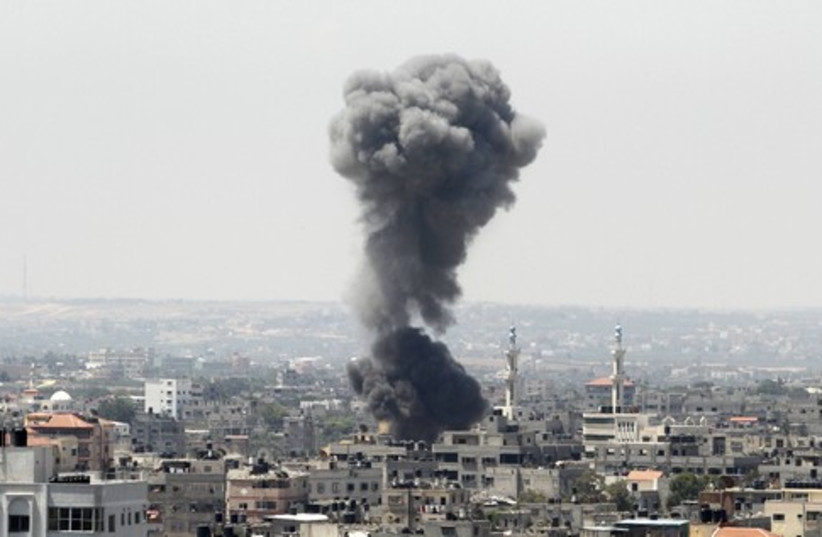 Smoke rises following what witnesses said was an Israeli air strike in Gaza City (photo credit: REUTERS)