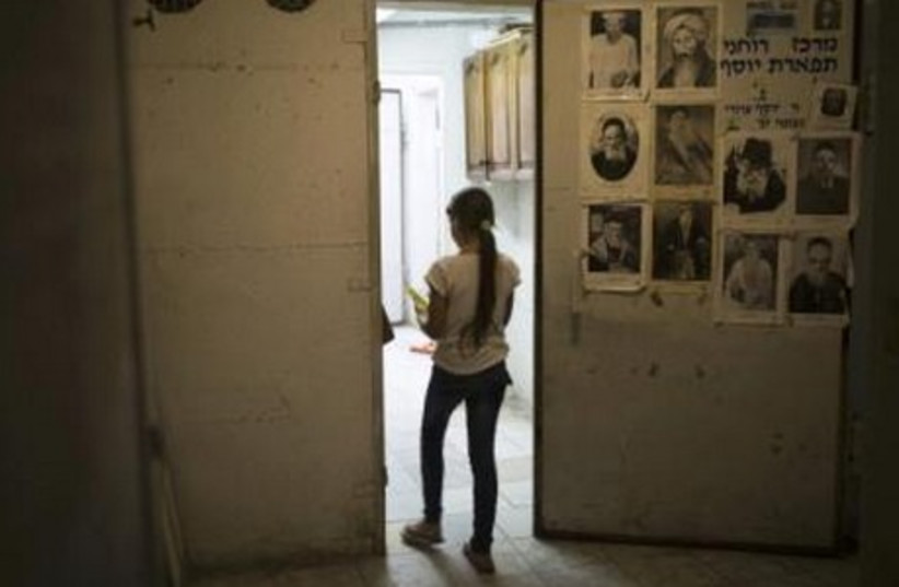 An Israeli girl walks in a bomb shelter in the southern city of Ashkelon July 8, 2014. (photo credit: REUTERS)