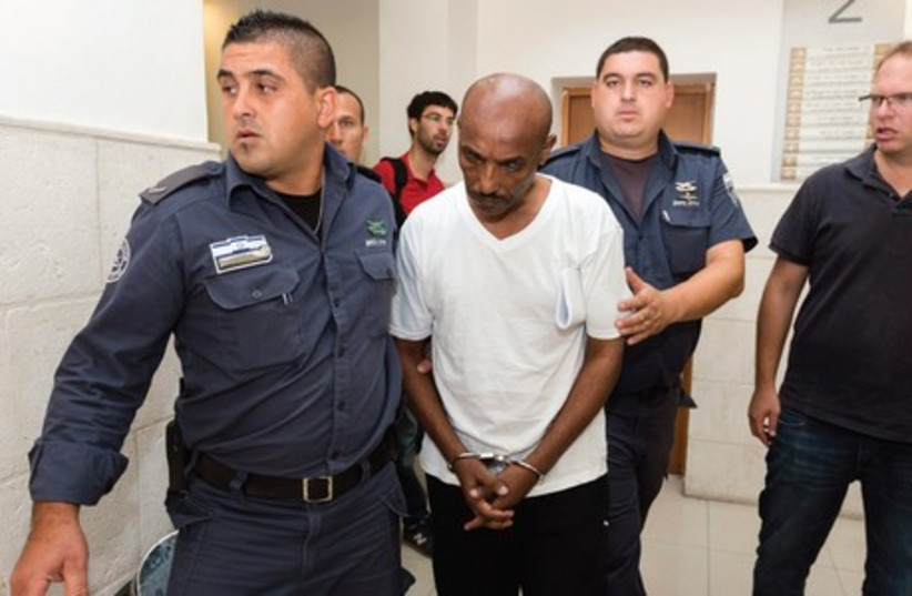PRISONS SERVICE personnel bring Tadesa Getahon to Jerusalem District Court. (photo credit: FLASH 90)