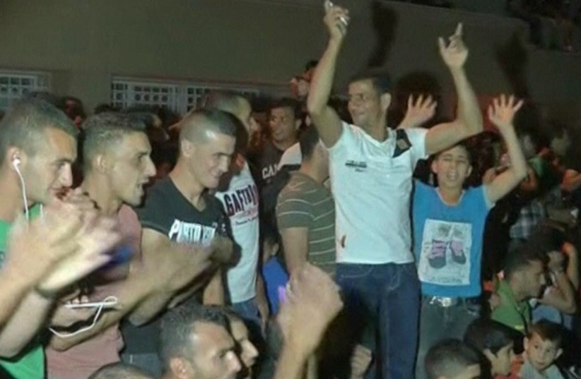 Palestinians in Hebron cheer as Gaza rockets fly toward Israeli population centers. (photo credit: screenshot)