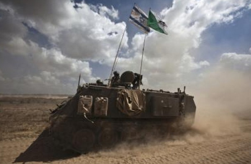 IDF armored personnel carriers (APCs) drive outside the Gaza Strip. (photo credit: REUTERS)