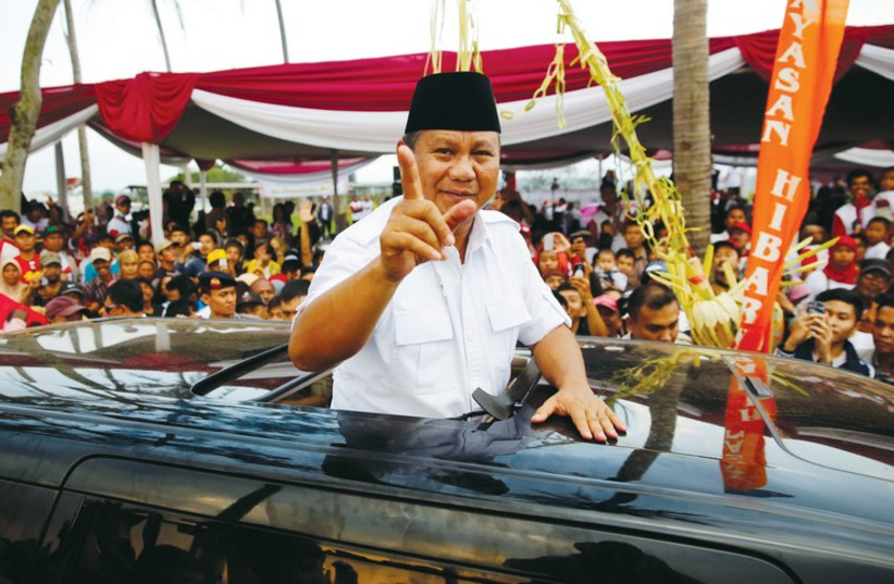 Indonesia's presidental candidate Prabowo Subianto gestures as he leaves a campaign rally in Ciparay near Bandung, West Java, on July 3. (photo credit: REUTERS)