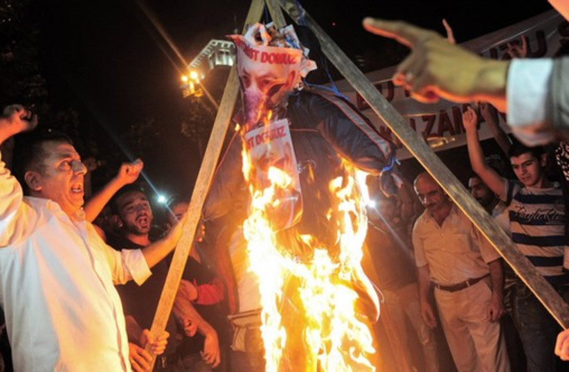 Pro-Palestinian demonstrators set fire to an effigy of Prime Minister Binyamin Netanyahu as they protest against Israel's military action in Gaza, outside the Israeli consulate in Istanbul, early July 19, 2014. (photo credit: REUTERS)