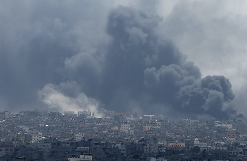 Smoke rises during what witnesses said were heavy Israeli shelling at the Shejaia neighbourhood in Gaza City (photo credit: REUTERS)