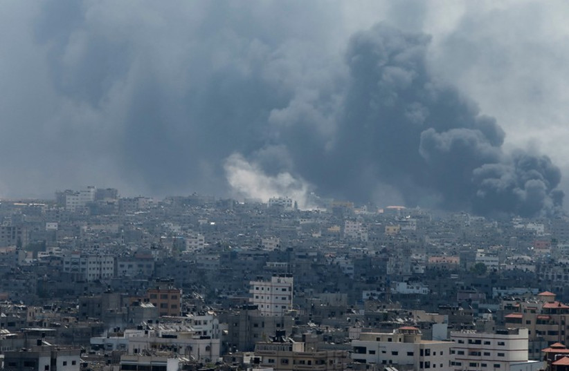 Smoke rises from Gaza's Shejaia district (photo credit: REUTERS)
