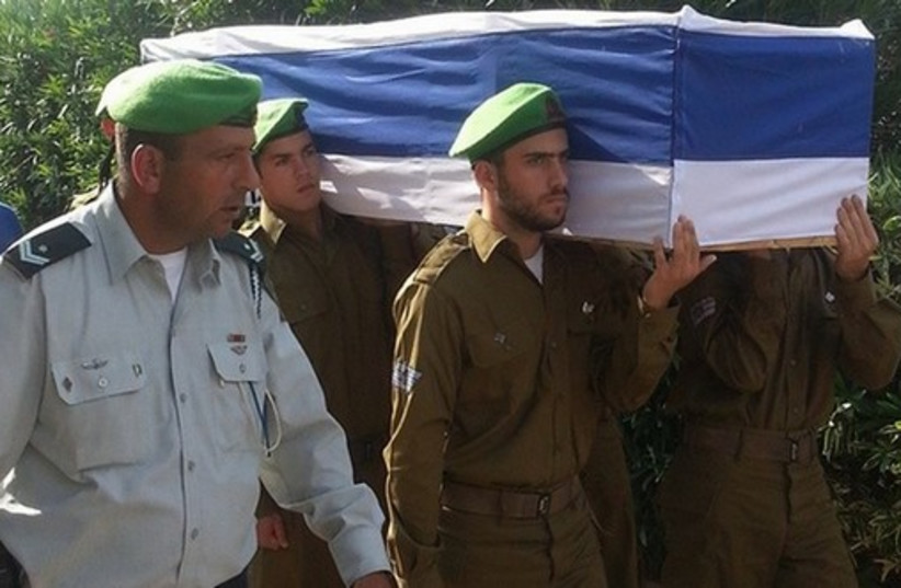 Nahal Brigade soldiers carry Sgt. Eitan Barak, 20, to his resting place. (photo credit: BEN HARTMAN)