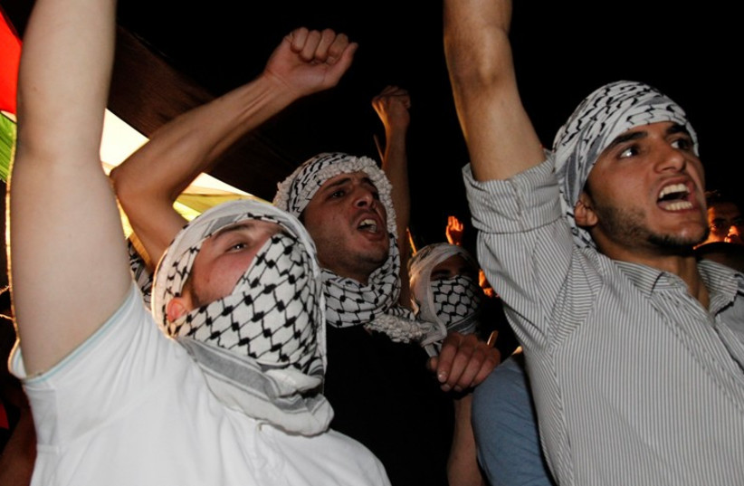 Protesters shout anti-Israel slogans during a protest in Amman (photo credit: REUTERS)