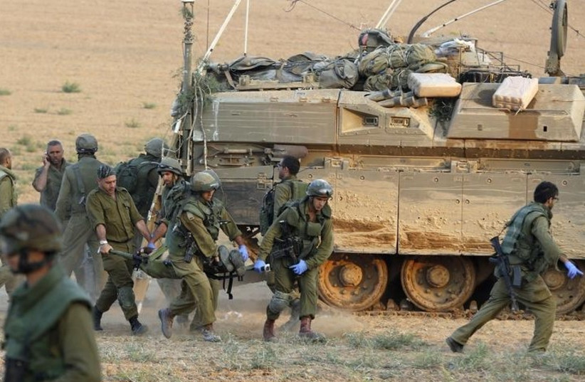 IDF extracts wounded soldiers from Gaza (photo credit: REUTERS)